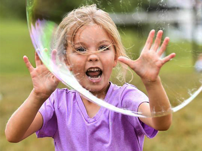 Picture of a little girl interacting with a large bubble